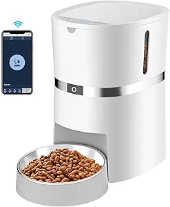 A sleek, white automatic pet feeder with a stainless steel bowl filled with kibble, alongside a smartphone displaying a companion app for controlling the device.